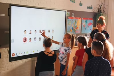 Kids playing with a clevertouch screen in classroom