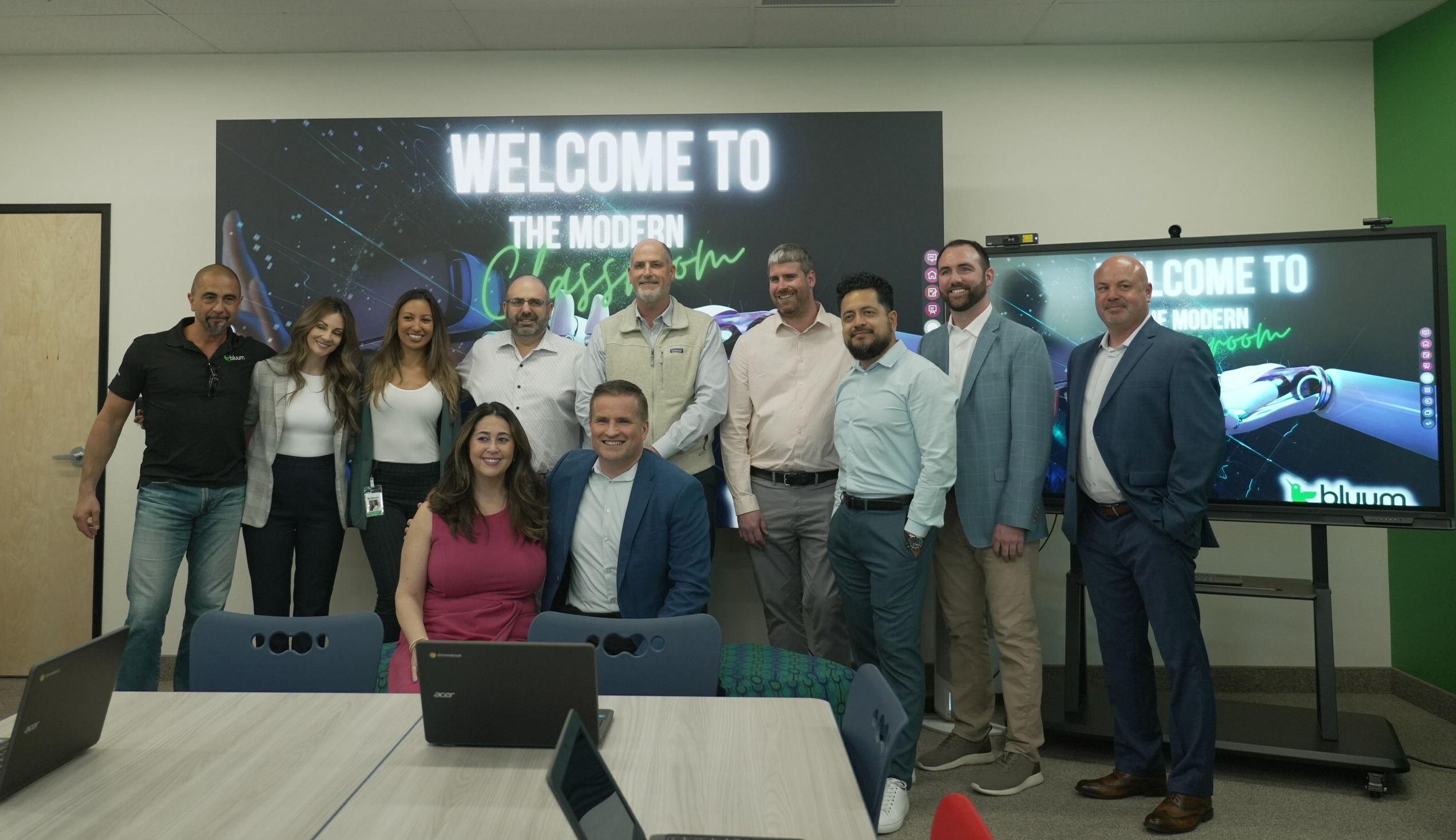 Group of adults standing in front of a screen that says Welcome to the Modern Classroom