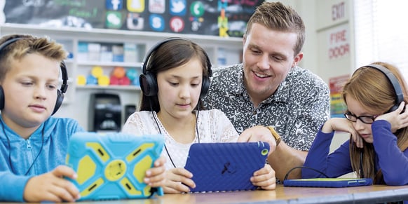 kids and teacher on tablets