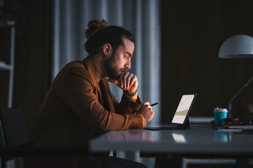 lifestyle-bluum-man-thinking-with-pen-and-laptop