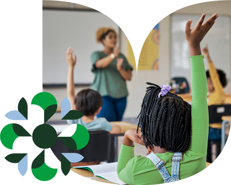 kids raising their hands in a classroom