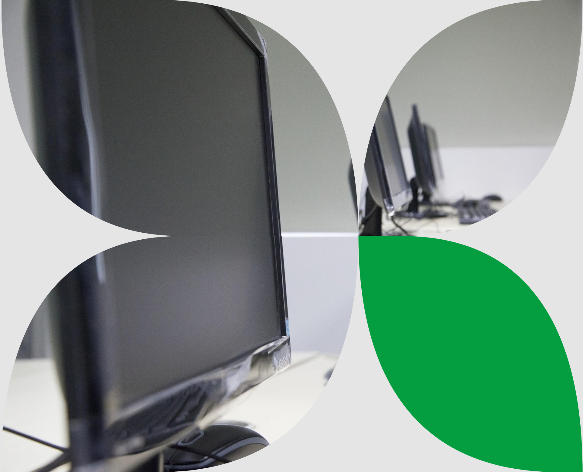 Computer lab learning environment with a row of desktops lined up on a desk.