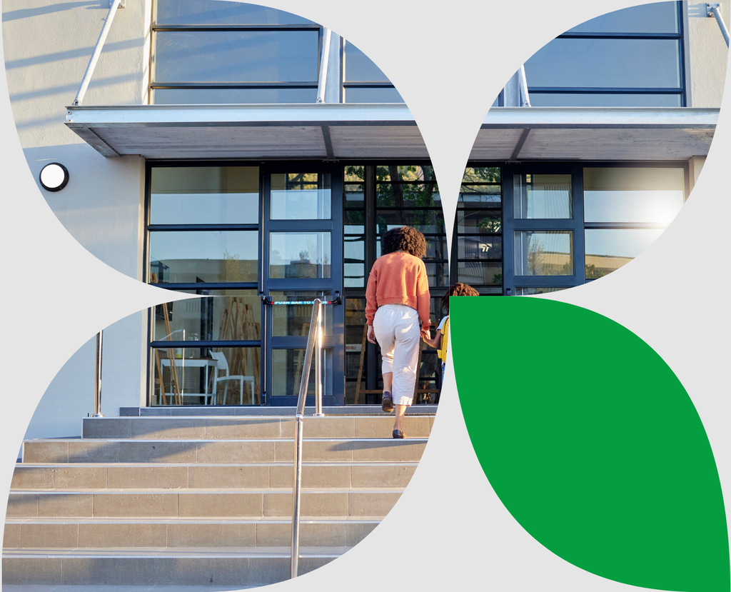 Mother walking her child to school, where a school visitor management system helps manage campus access