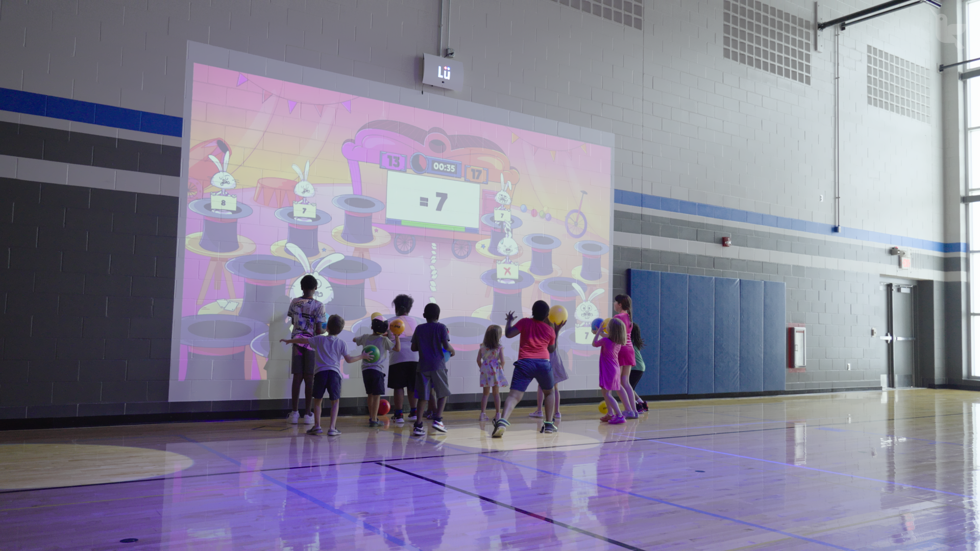 kids playing with lu in a gym