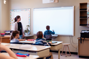 Teacher and student at an interactive white board.