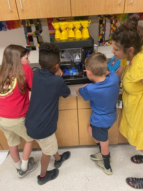 Calcasieu Parish students interact with a 3D printer in their classroom. 